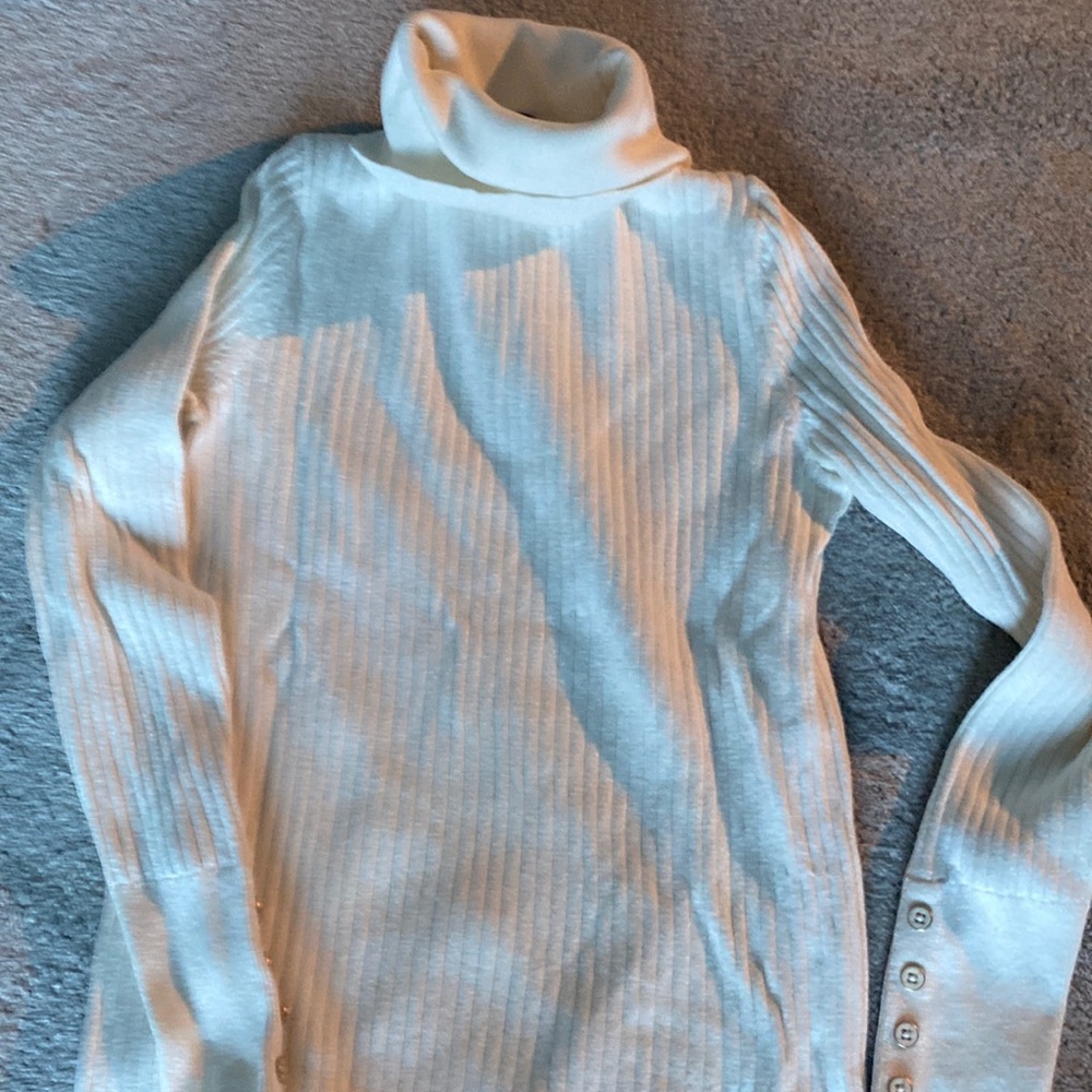 White gently used ribbed turtleneck with buttons on sleeves